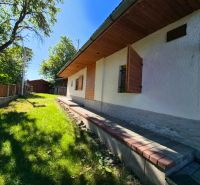 A family house in Mikušovce with shutters and nearby natural surroundings.