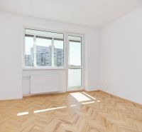 A bright room with a wooden decor floor in a 3-room apartment.