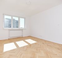 Bright room with wood-patterned flooring in a 3-room apartment.
