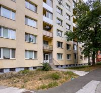 Apartment building on Benadová Street, Dargovských hrdinov, Košice, surrounded by a sidewalk and trees.