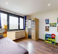 Children's room in a 4-room apartment with a wooden decor floor and decorations on the walls.