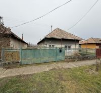 A family house in Sikenica with an older fence and a garden, surrounded by other houses.