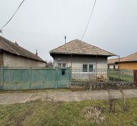 A family house in Sikenica with a metal fence and a sloped roof.