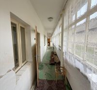 A bright hallway in a family house with carpet and curtains.