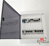 An electrical distribution box in a 4-room apartment with open circuit breakers.