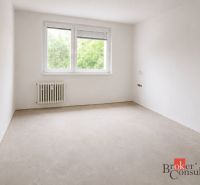 A kitchen in a 4-room apartment with a wooden decor floor and a large window.