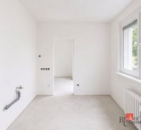Empty room in a 4-room apartment with light walls and large windows.