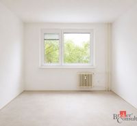 A bright room with trees outside the window, a radiator, and a wooden decor floor in a 4-room apartment.