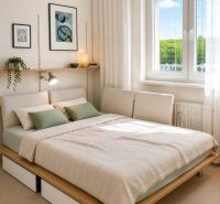 Bedroom with a bed, two pillows, minimalist decoration in a 2-room apartment.
