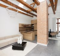 Living room in a 3-room apartment with a brick wall and a wooden decor floor.