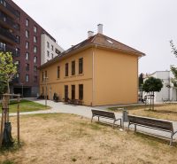 Renovated building with a courtyard and benches on Továrenská Street in Košice, Old Town district.