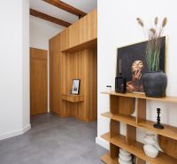 Interior of a 3-room apartment with wooden decor and elegant accessories.