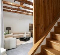 A staircase with a wooden decor floor leading to the living room in a 3-room apartment.