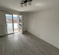 A room in a 3-room apartment with a wood-patterned floor and a balcony.