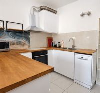 A kitchen in a 2-room apartment with a wooden decor and modern design.