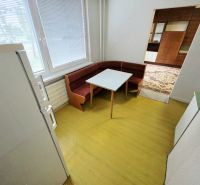 A kitchen in a 3-room apartment with a corner bench and table.