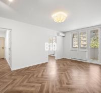 Living room in a 3-room apartment with a patterned floor featuring a wood design.