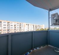 A view from the balcony of a one-room apartment in Nitra overlooking the surrounding apartment buildings.