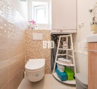 A bathroom in a family house with tiles and modern equipment.