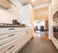 A kitchen in a family house with a cooktop and a built-in oven.