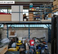A stocked warehouse hall with various equipment and pallets in a family house.
