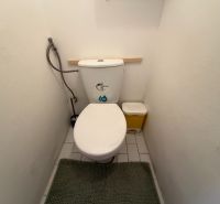 A bathroom of a 3-room apartment with white walls and tiles.