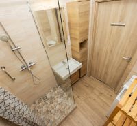 Bathroom in a 3-room apartment with wooden decor and a shower corner.