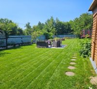 Garden at Kamenný Mlyn in Trnava with a garden house and a trampoline.