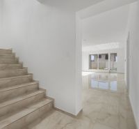 Stairs and a bright hallway in a family house, floor with wooden decor.