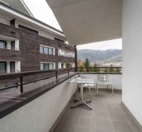 The balcony of a recreational apartment in Donovaly with a view of the surrounding mountains.