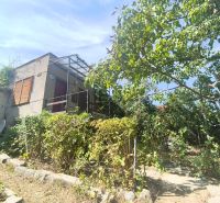 Gardens in Lučenec with a garden cottage and trees, ideal for relaxation and cultivation.