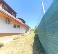 A family house in Divín with air conditioning, fencing, and a garden with a lawn.