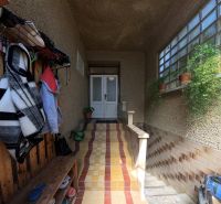 Entrance area of a family house with jackets and potted plants.