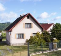 A family house on Na Vrších Street in Sázava with a large garden and a hilly background.