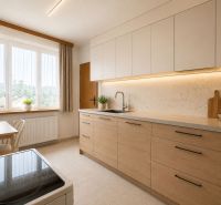 A kitchen in a family house with a floor, wooden decor, and a light cabinet.