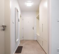 Entrance hallway in a 2-room apartment with tiles and built-in wardrobes.