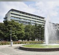 Fountain at Račianske Mýto in Bratislava - Nové Mesto with an apartment building in the background.