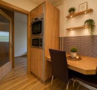 Dining area with wooden decor in a 3-room apartment.