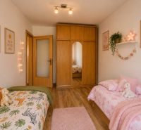 Children's room in a 3-room apartment with beds, pictures of a giraffe and a unicorn.