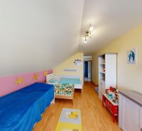 Children's room with beds, shelves, decorative furniture, and a wooden decor floor.