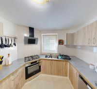 A kitchen in a family house with countertops and appliances, wooden decor furniture.