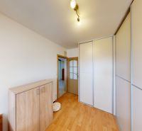 Interior of a family house with a wooden decor floor and a built-in wardrobe.