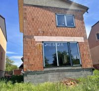 A family house in Cerová in the construction phase with an unplastered brick facade.