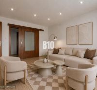 Living room in a 3-room apartment with a wooden decor floor and neutral furniture.
