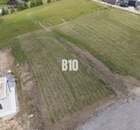 A flat plot in Bitarová ideal for living, surrounded by nature and modern buildings.
