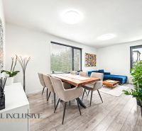 Living room with a dining table, sofa, and wood-patterned flooring in a 3-room apartment.