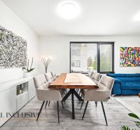 A spacious living room with a wooden table and comfortable seating in a 3-room apartment.