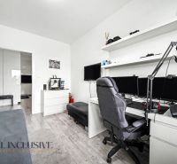 A study with a computer, shelves, and a wooden decor floor in a 3-room apartment.