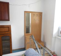 In a 2-room apartment, there is a coat rack with a mirror and a storage cabinet.