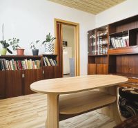 Living room with cabinets, books, flowers, and a wooden decor floor in a 4-room apartment.
